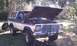 1979 Ford Bronco - A two-tone white and dark blue Ford Bronco sits outdoors with its hood open, revealing the engine bay.