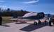 1979 Ford Bronco - Airplanes parked on tarmac with people nearby on a sunny day.