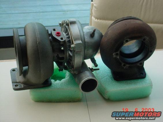 Two turbochargers, one new and one rusty, side-by-side