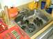 1996 Ford Bronco - Various automotive components, including chains and gears, are soaking in a sink next to a toolbox and cleaning supplies.
