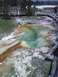 2007 Dodge Caliber - A vibrant geothermal pool displays a spectrum of colors from mineral deposits, bordered by a wooden boardwalk and surrounding vegetation.