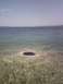 2007 Dodge Caliber - A natural opening in the water creates a dark circle, with the seabed visible through the clear water.