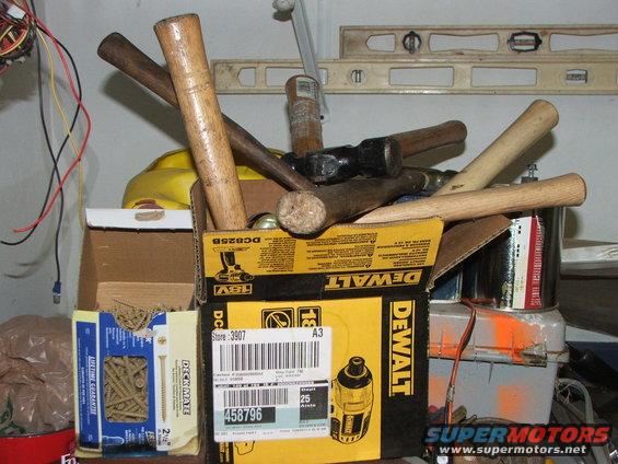 Box of hammers and tools, including a DeWalt box with a label that says store 3907 and item number 458796