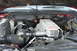 1994 GMC Sierra 3500 - The engine bay features a Turbo Power cover and is visible under the hood of a red vehicle.