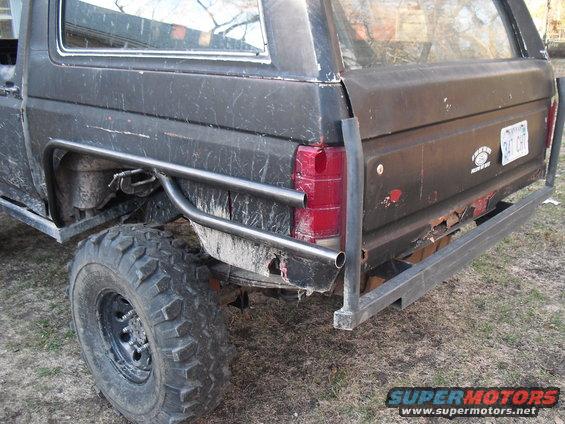 Black SUV rear view with custom roll cage and bumper. License plate reads CHT 247