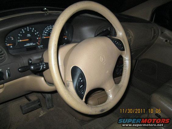 Car interior showing dashboard, steering wheel with controls, and gauges. Date stamp reads 11/30/2011