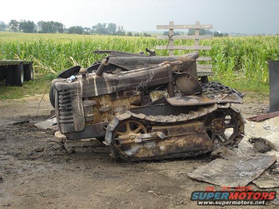 Burnt tractor with tracks in a field