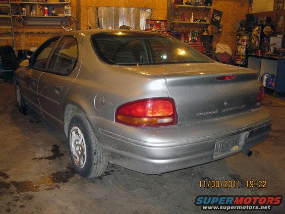 Rear view of a silver Dodge Stratus sedan parked indoors. License plate NTB-748