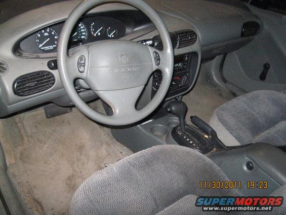 Gray interior with Dodge logo on steering wheel and automatic transmission shifter
