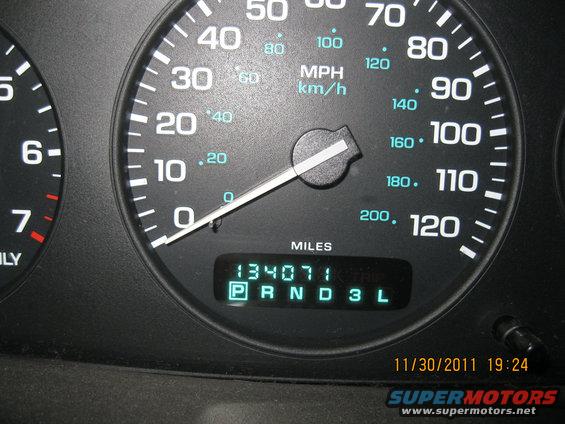 Close-up of a car's dashboard gauges showing speedometer, tachometer, and digital odometer reading 134071 miles