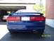 1993 Ford Probe - Rear view of a blue 1993 Ford Probe GT, parked in front of a garage with another vehicle inside.