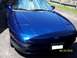 1993 Ford Probe - A blue 1993 Ford Probe is parked outside on a sunny day, with a sunshade visible through the windshield.