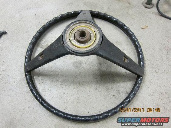 Black steering wheel with three spokes and a textured rim