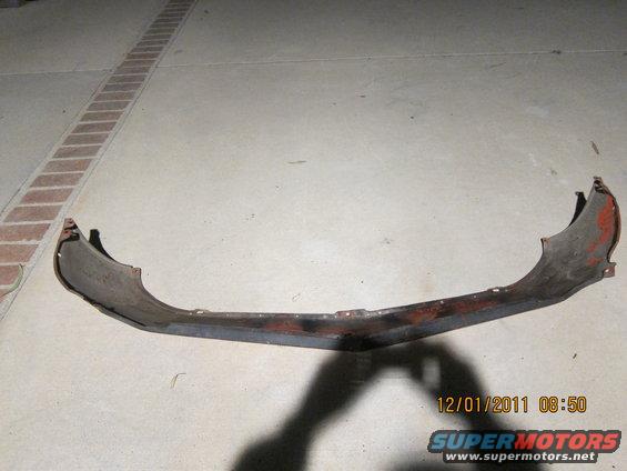 worn car bumper with red paint visible on edges