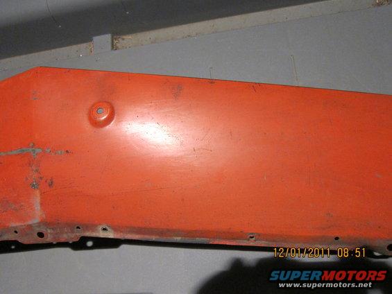 Orange painted metal panel with a circular indentation and mounting holes. Date stamp 12/01/2011
