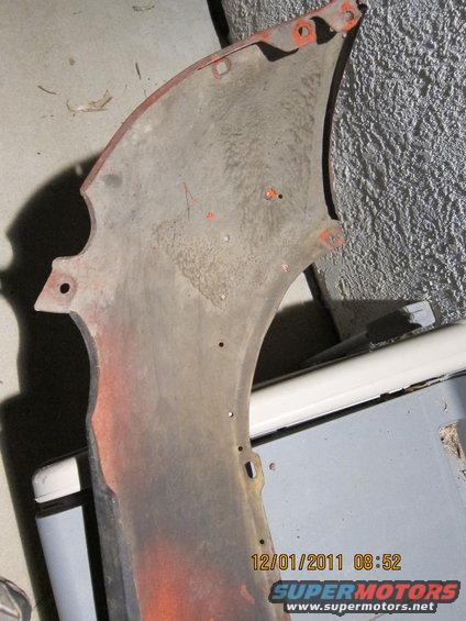 Fender part with orange undercoating and mounting holes