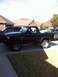 1985 Ford Bronco - This black Ford Bronco is parked in a suburban driveway with houses in the background.