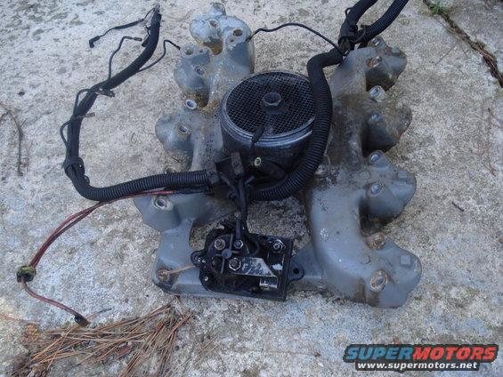 Engine intake manifold with attached wiring harness and electrical connector