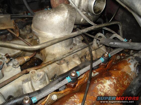 Close-up of engine components including fuel lines and a turbocharger housing