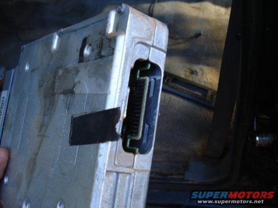 Engine control module with connector port, held in hand