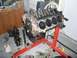 1996 Ford Bronco - Engine block and associated parts are laid out on the floor and an engine stand.