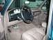 1996 Ford Bronco - Interior view of a 1996 Ford Bronco, showing the dashboard, steering wheel, and tan leather seats.