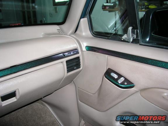 1996 Ford Bronco interior with Eddie Bauer badging and green glitter trim on the dash and door panel