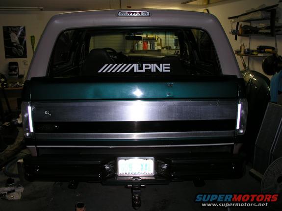 Green and grey Ford Bronco rear with a license plate and an Alpine sticker on the rear window