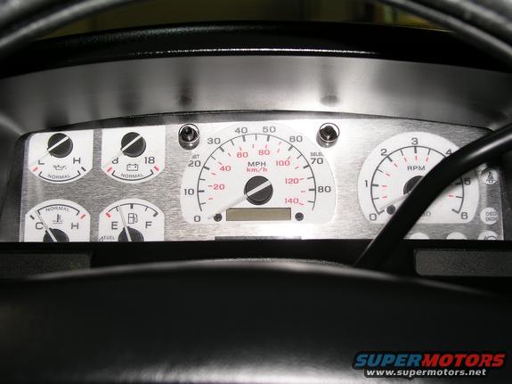 Dashboard gauges including speedometer, tachometer, fuel, oil, and temperature