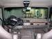 1996 Ford Bronco - The interior of a 1996 Ford Bronco features a tan dashboard with wood trim and a factory radio.