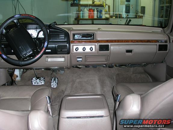 Tan interior of a 1992 Ford F-150 pickup truck, showing the dashboard, steering wheel, and seats