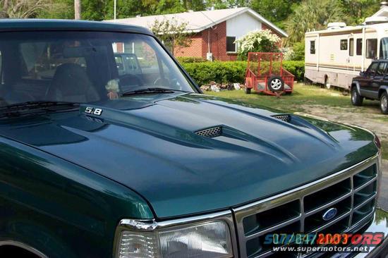 Green 1996 Ford Bronco 3q-front view with hood scoop and '5.8' badge