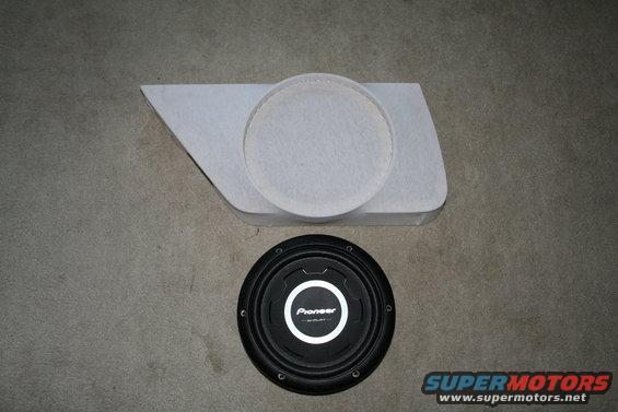 Car door panel with a circular cutout and a Pioneer subwoofer