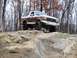 1989 Ford Bronco - Ford Bronco navigates a rocky trail in a wooded area.