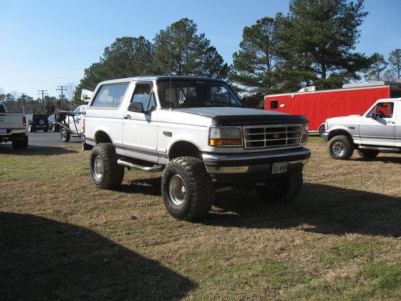 White 1994 Ford Bronco with lifted suspension and large tires