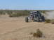 1988 Ford Bronco - This off-road buggy is racing through a dusty desert landscape.