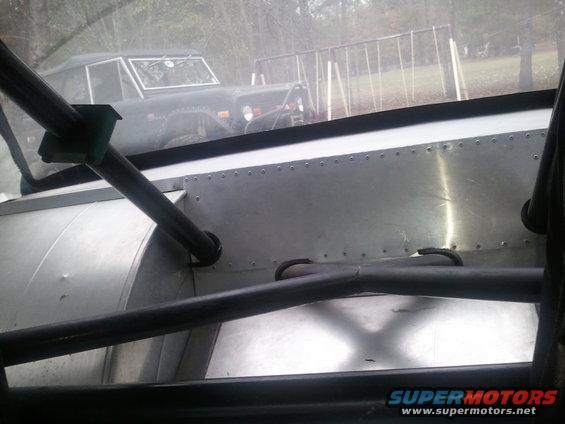 Dark Ford Bronco front view, seen through interior roll cage