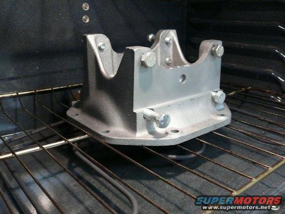 Metal car part on oven rack