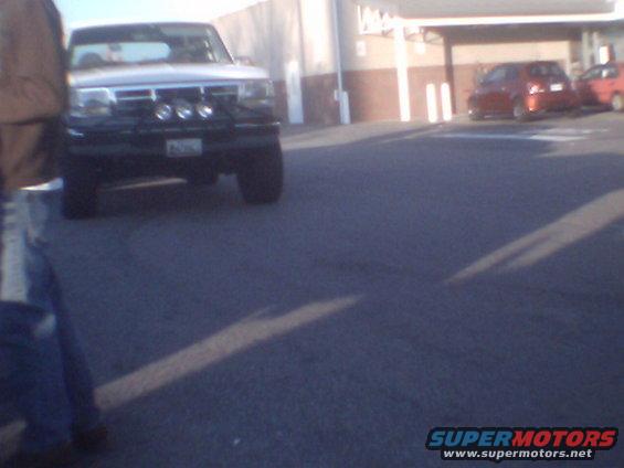 White pickup truck with auxiliary lights on front grille