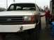 1989 Ford Bronco - A person dressed as Santa Claus fuels a 1989 Ford Bronco at a gas station.