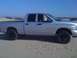 2005 Dodge 1500 - Silver 2005 Dodge 1500 pickup truck with crew cab and aftermarket wheels on sand dunes.