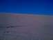 2005 Dodge 1500 - Tire tracks mark the sandy slopes of dunes under a bright blue sky.