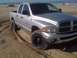 2005 Dodge 1500 - This silver Dodge 1500 pickup truck is seen on a sandy beach, equipped with aftermarket wheels and tires.