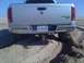 2005 Dodge 1500 - Rear view of a 2005 Dodge 1500 pickup truck driving on sand.