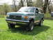 1990 Ford Bronco - This 1987 Ford Bronco is shown in a three-quarter front view, parked outdoors on a sunny day.