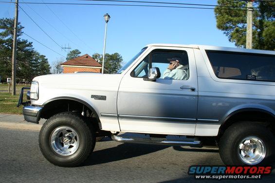 Side view of a white and silver 1992 Ford Bronco with running boards