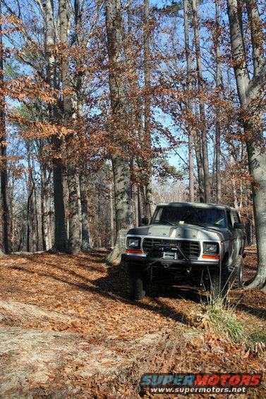 Gray Ford Bronco with aftermarket bumper and winch, front 3/4 view