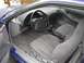 1993 Ford Probe - The interior of a 1993 Ford Probe, its dashboard, steering wheel, and patterned seats.