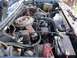 1985 Ford Bronco - The engine bay of a 1985 Ford Bronco, showing the air cleaner assembly, battery, and various engine components.