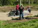 1993 Suzuki Sidekick - An SUV is stuck in a mud pit while onlookers observe the situation.